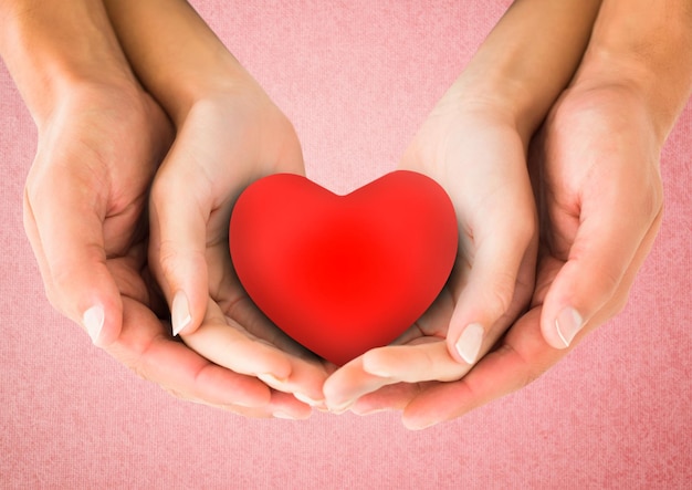 Hands of couple holding a heart