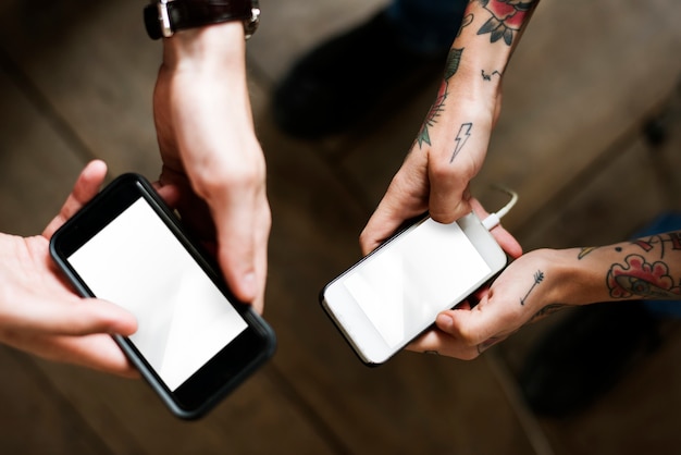 Hands of couple using mobile phones