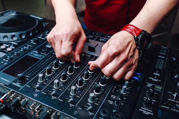 Photo hands dj mixing music at the club during the event