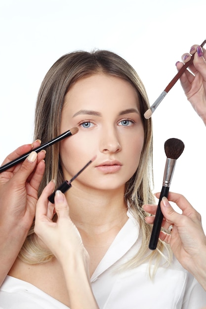 hands doing make up young beautiful girl
