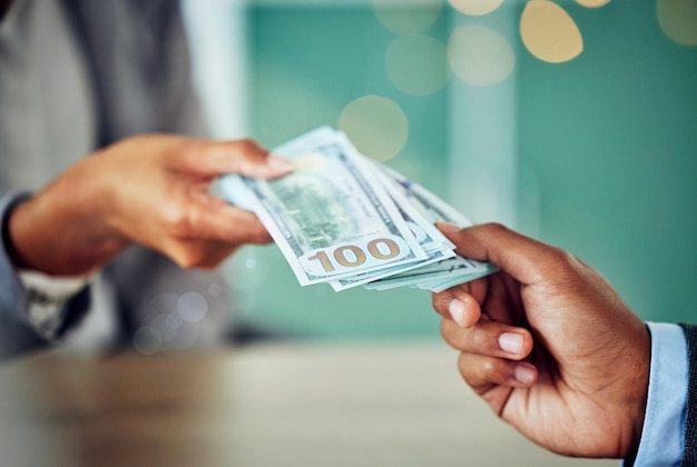 Hands dollars and businessmen exchanging cash at a bank making a purchase or deal Closeup of money investment and business doing its accounting African entrepreneur paying for a service or loan