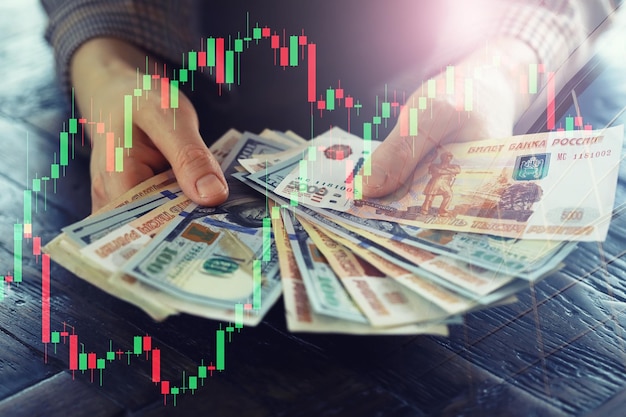 Hands exchanging Russian banknotes and American dollar money concept of currency exchange