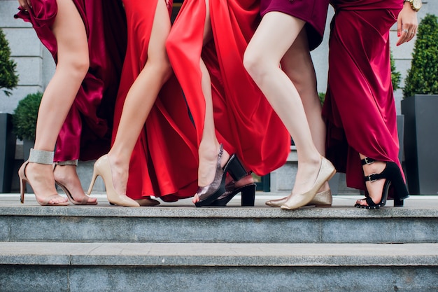 Hands and feet women in heels, lifted their right leg