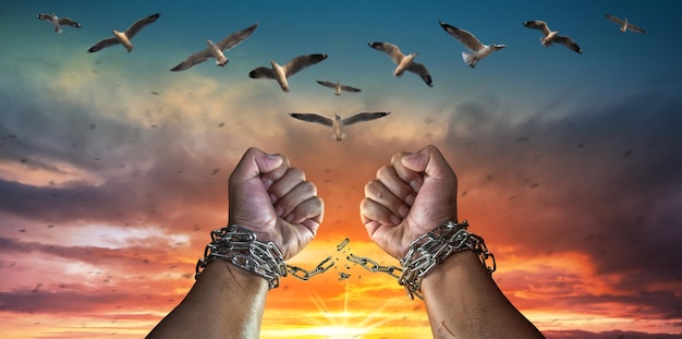 Hands in fists breaking a chain freedom The concept of gaining freedom