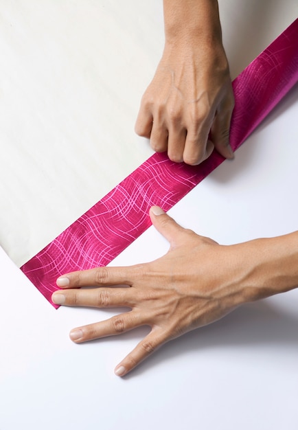 Photo hands folding paper for wrapping present