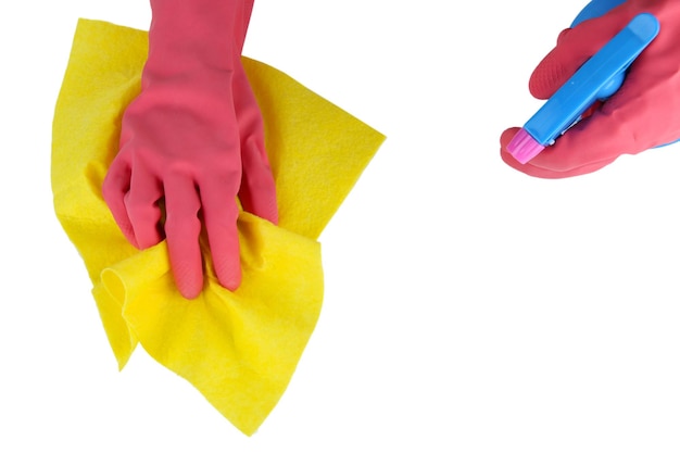 Hands in gloves wiping surface with yellow rag and spray isolated on white