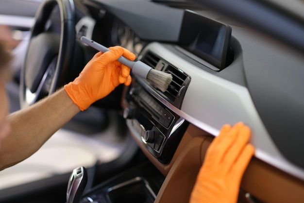 Hands in gloves with a dust brush detailing