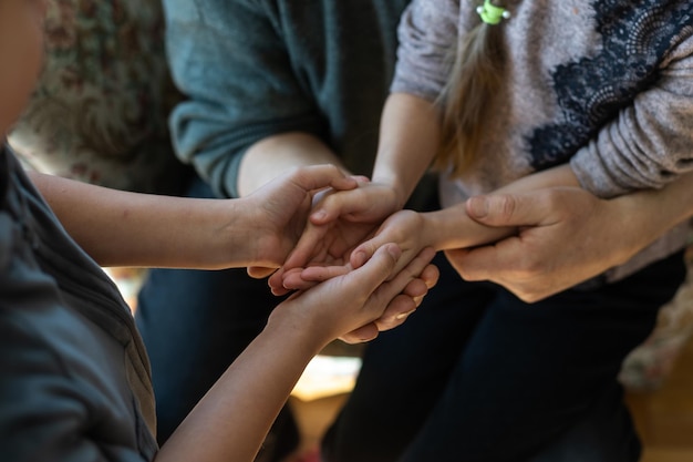 hands of grandfather and granddaughter with prayer.