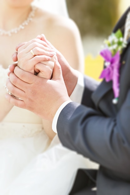 Hands of the groom and the bride with wedding rings