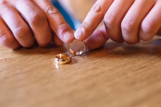 Hands of the groom with rings thoughts of marriage