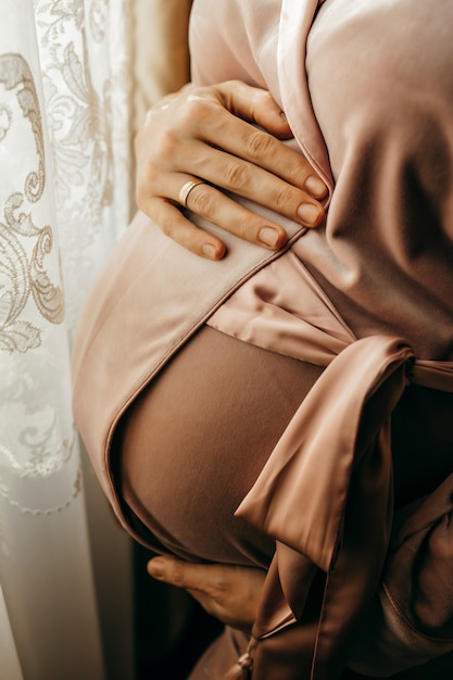 Hands of happy pregnant woman closeup