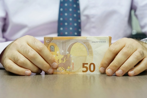 Hands hold and counting euro banknotes