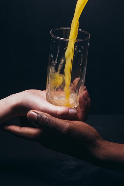 Hands hold glass pouring juice Healthy life