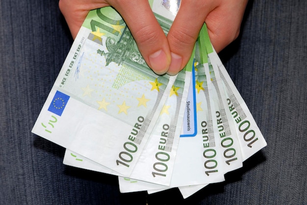 Hands holding 500 EUR tuition fees