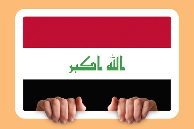 写真 hands holding a white frame with iraq flag protest or social issues in iraq two hands and frame