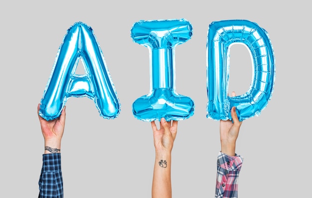 Photo hands holding aid word in balloon letters