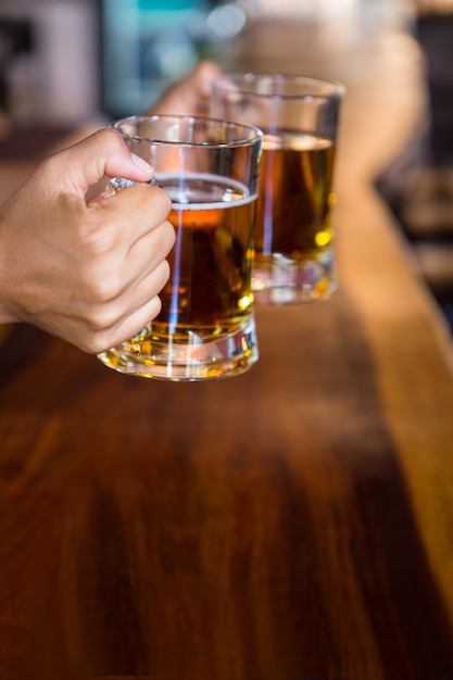 Hands holding beer