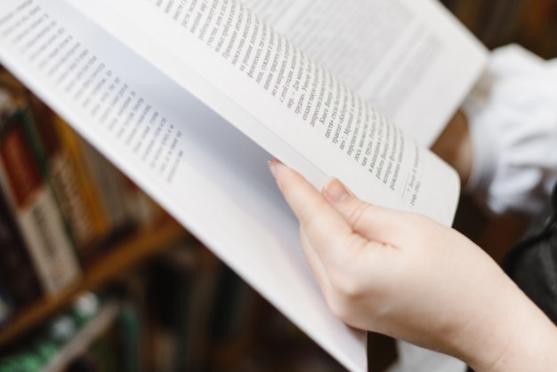 Hands holding a big book