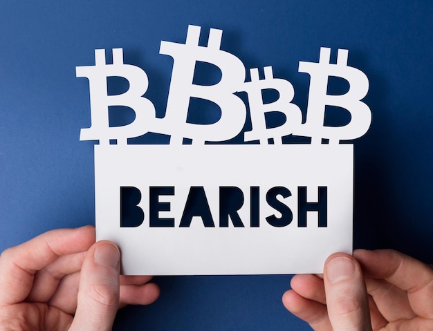 Hands holding a bitcoin cryptocurrency bearish sign