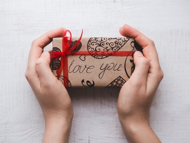 Hands holding a box with a gift