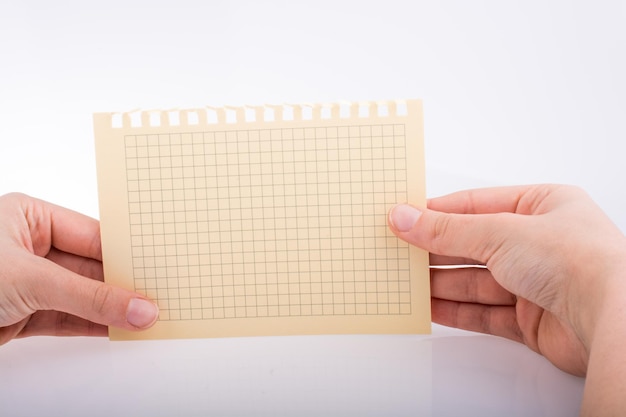 Hands holding a checked paper