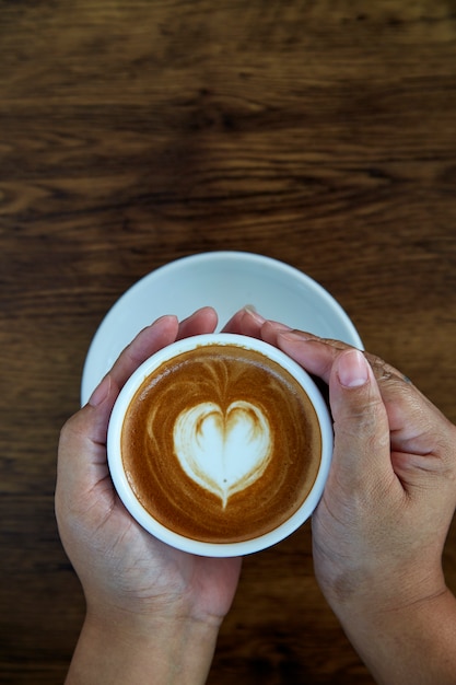 Hands holding coffee cup heart cup