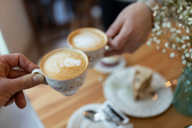 Hands holding coffee cups