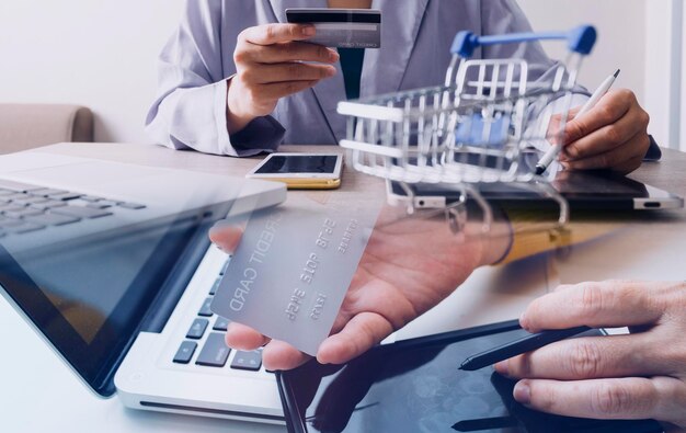 Hands holding credit card and using laptop Online shopping