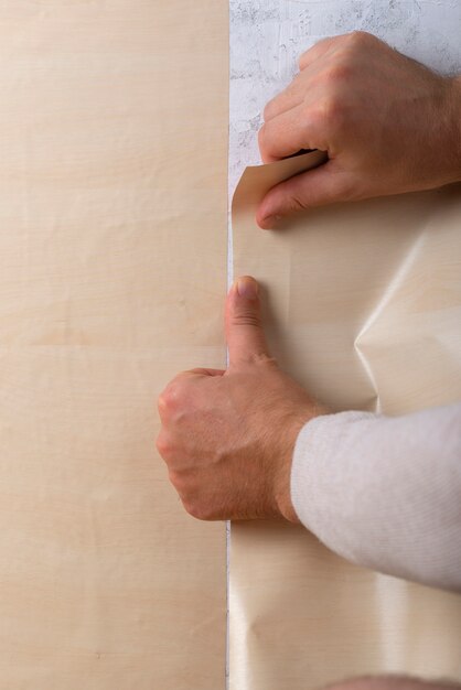 Hands holding  decorative vinyl above view