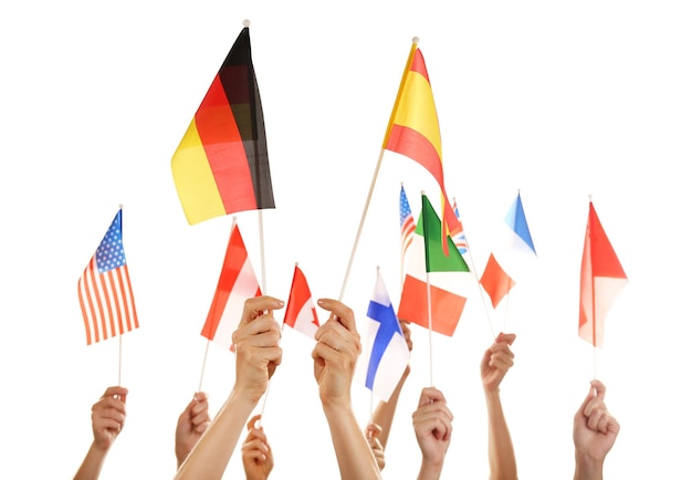 Hands holding different flags isolated on white