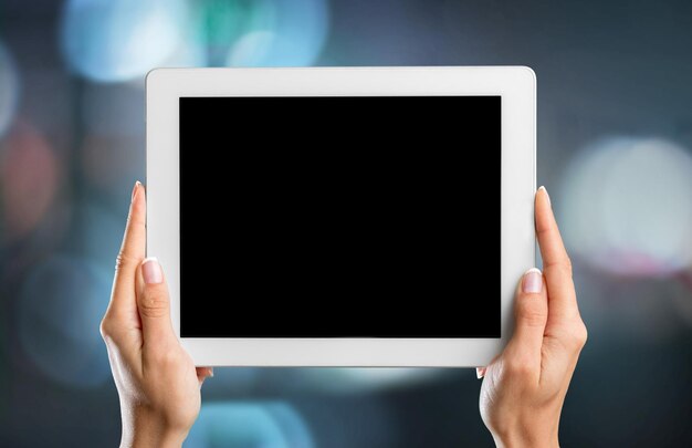 Hands holding digital tablet, close-up view