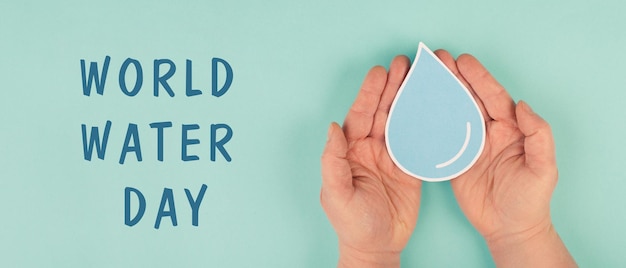 hands holding a drop of water, environmental issue, world water day