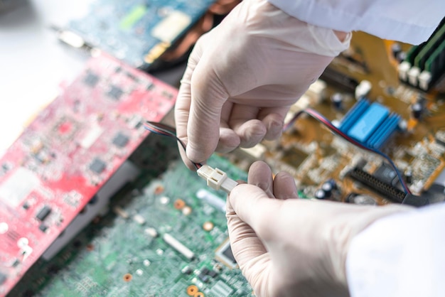 Hands holding the electronic components working on the electronic research in laboratory, developing technology industry