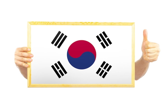 Foto hands holding a frame with south korea flag approvement or success in south korea independence