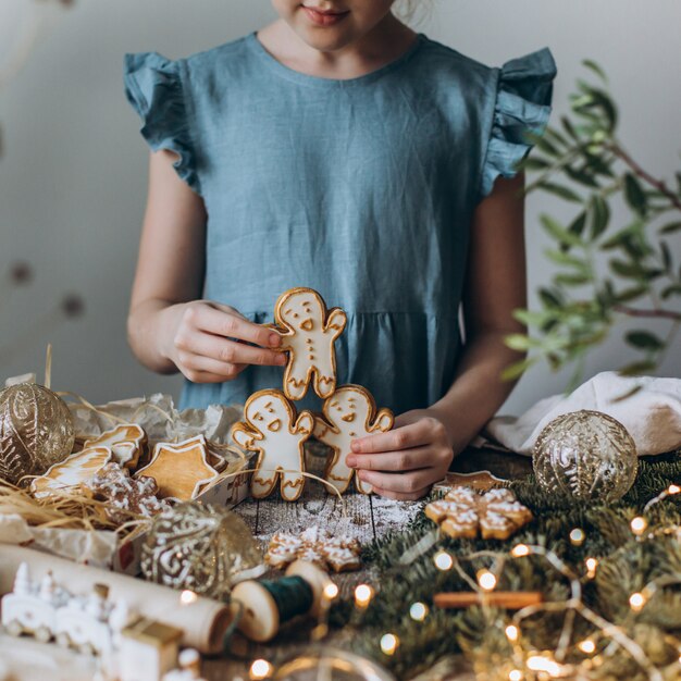 Hands holding gingerbread cookies