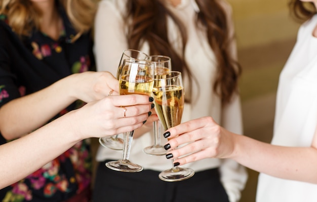 Hands holding the glasses of champagne making a toast