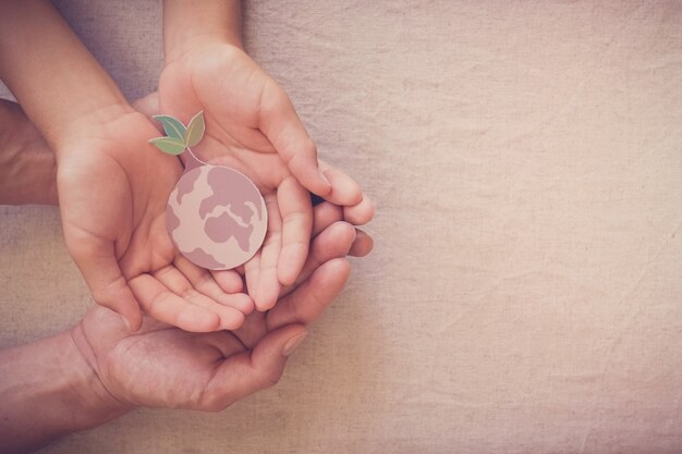 Photo hands holding growing tree on earth, save planet, earth day, ecology environment, climate emergency action, csr social responsibility, sustainable living concept