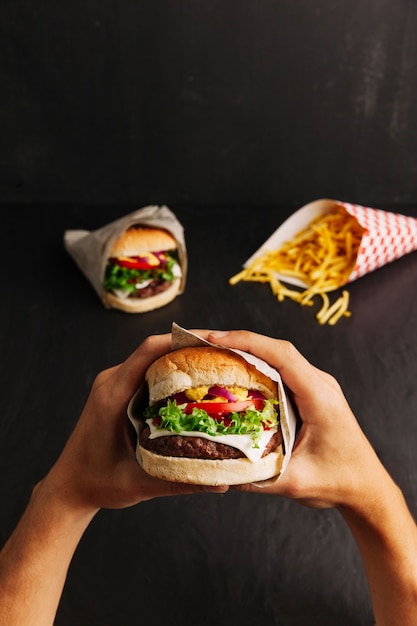 Hands holding hamburger