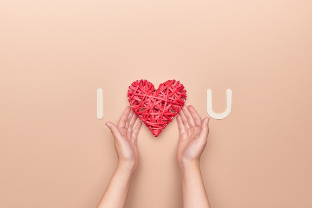 Руки держат украшение сердца в любовной цитате на День святого Валентина