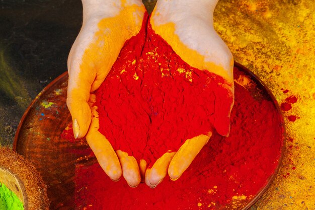 Hands holding holi powder paint view from above