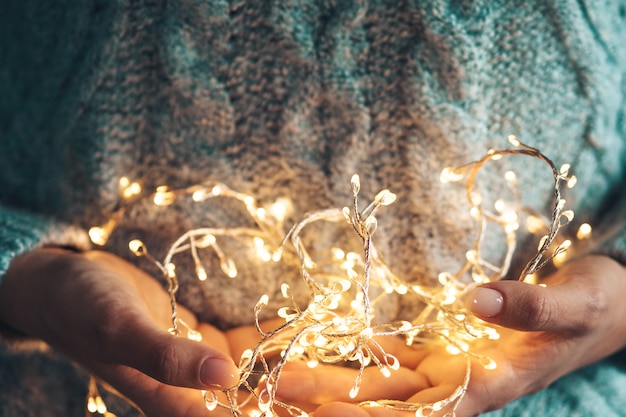 Hands holding lights garland