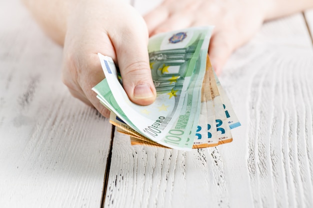 Hands holding a lot of money banknotes