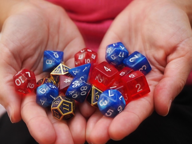 Hands holding a lot of RPG DND dice