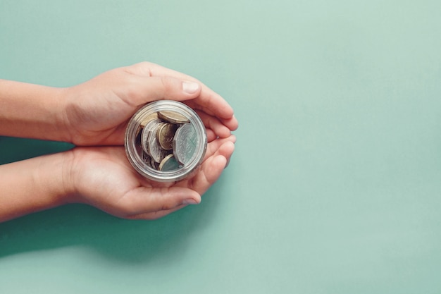 Hands holding money jar