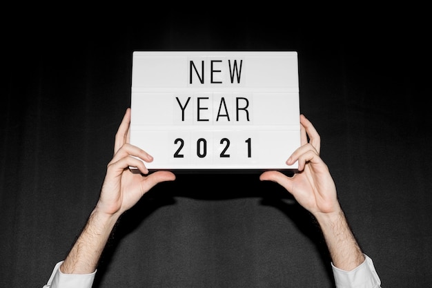 Photo hands holding new year 2021 sign