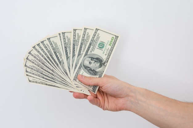 Hands holding a one hundred dollars bill  hands holding a lot of money  isolated on white background