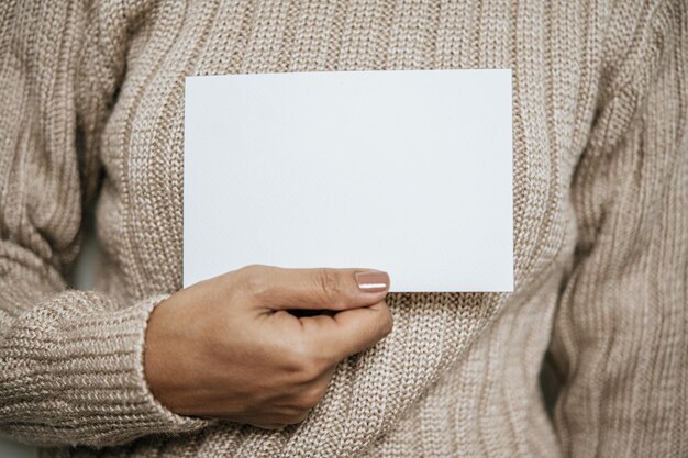 Photo hands holding opened card or letter blank cover mockup