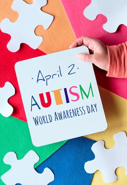 Photo hands holding page with text autism world awareness day