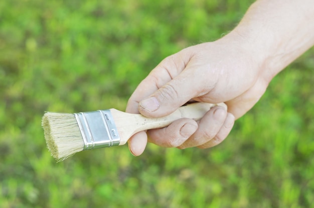 Hands holding a paint brush