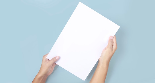 Hands holding paper blank for a letter paper